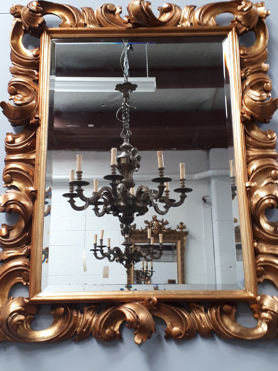 Early 20th Century French Rococo style gilt bevelled wall mirror. It has been sourced from France and is in good original condition. Circa 1920