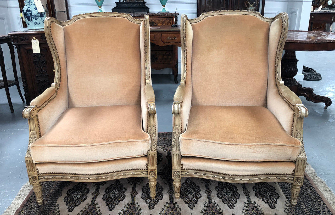 Pair of Vintage French original painted bergere wingback armchairs. The fabric is in very good original condition, please view photos as they help form part of the description. Please note the matching foot stool is being sold separately.