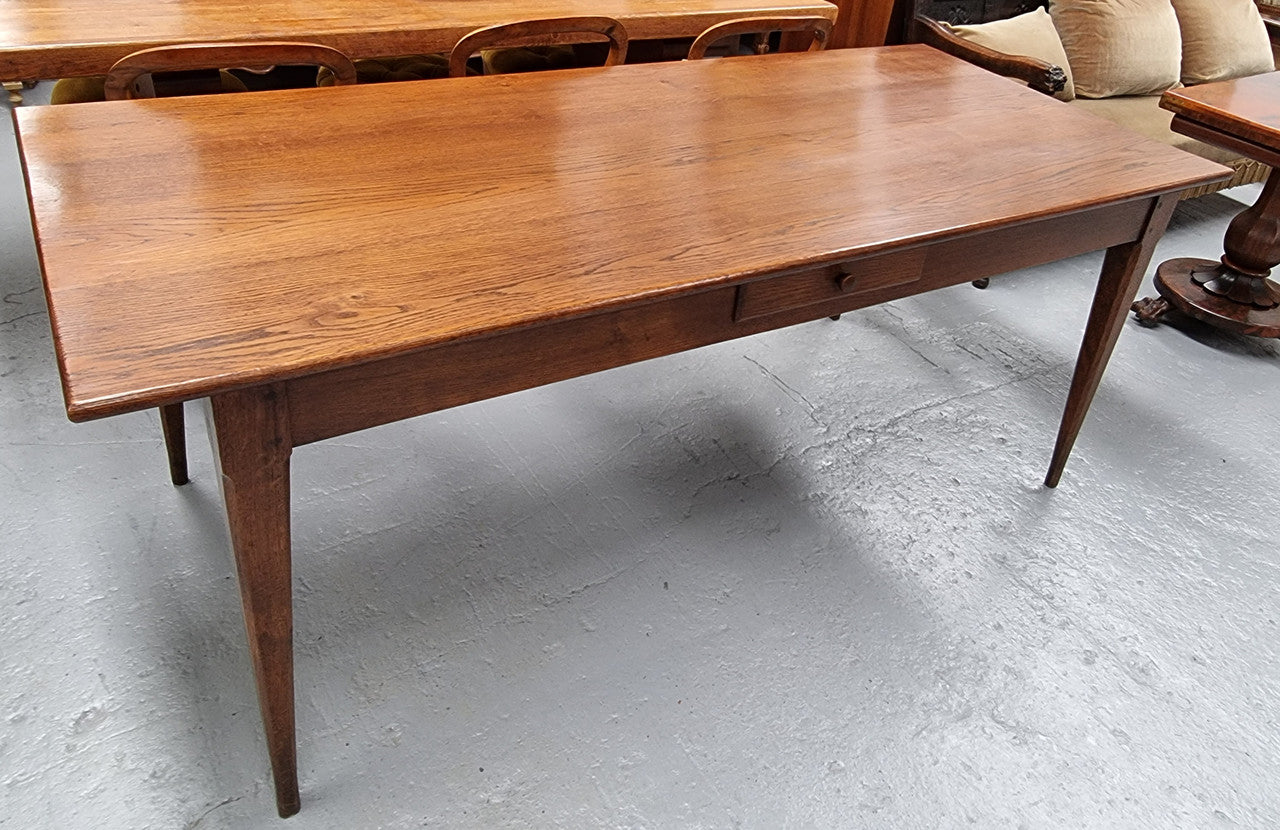 Antique French Oak Farmhouse table in fully restored condition. Features a single drawer and tapered legs.
