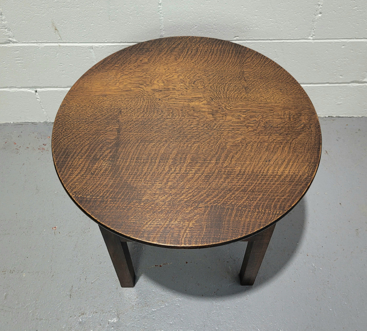 Fabulous round oak side table which also has a hidden sewing box underneath with lovely original blue satin lining and Includes pictured sewing items. It is in good original condition.