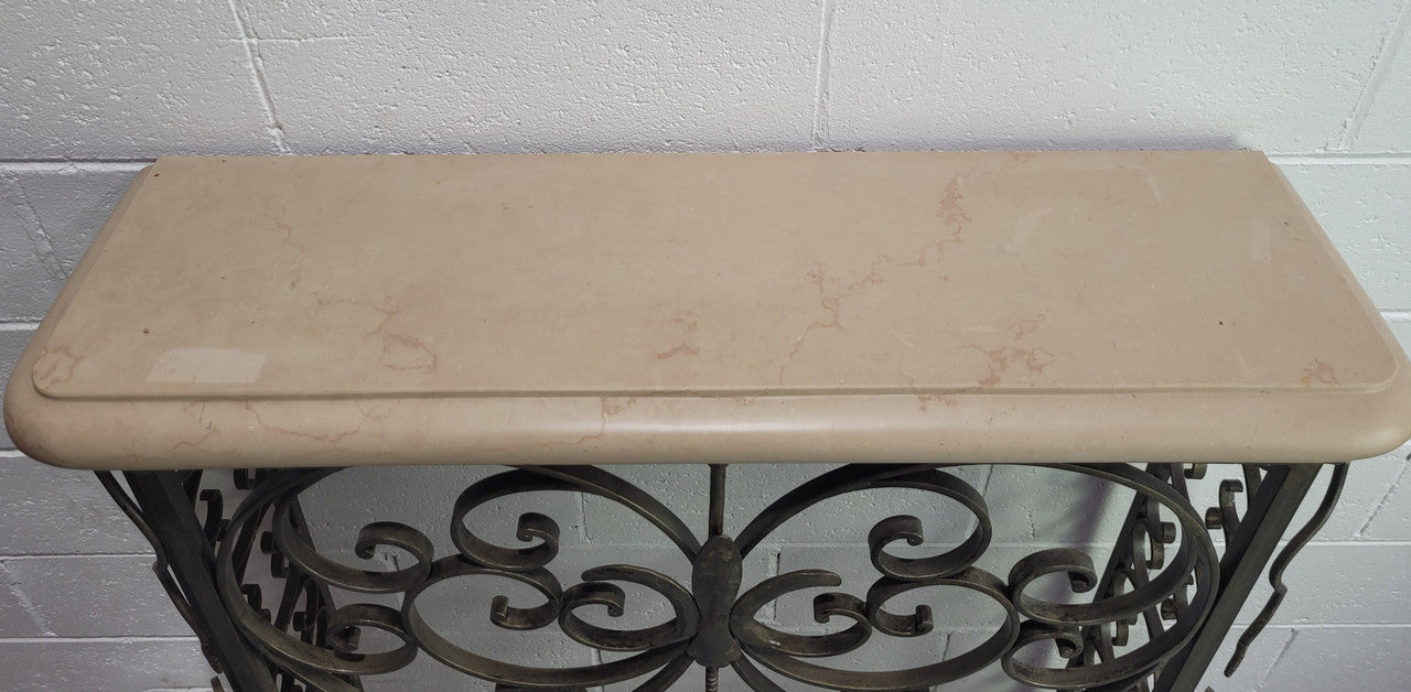 Stunning Art Deco wrought iron and marble top console table. It has amazing decorative iron work at the bottom and a beautiful marble top. It is in good original detailed condition.