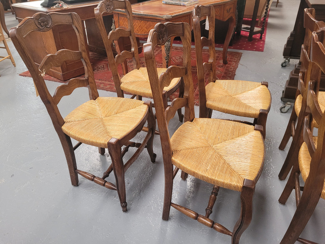 Set of six Louis XV style French Oak rush seat dining chairs. They are in good original detailed condition.