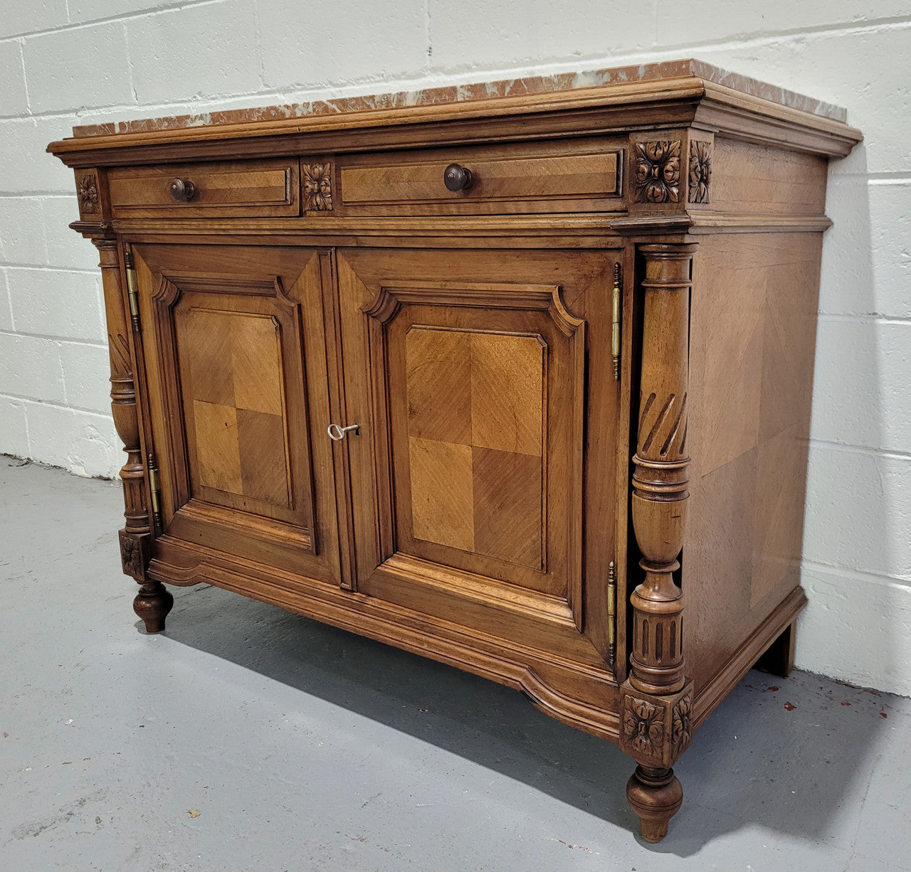 Stunning French walnut Henry II style marble top side cabinet with two drawers and two shelves inside. In good original detailed condition.