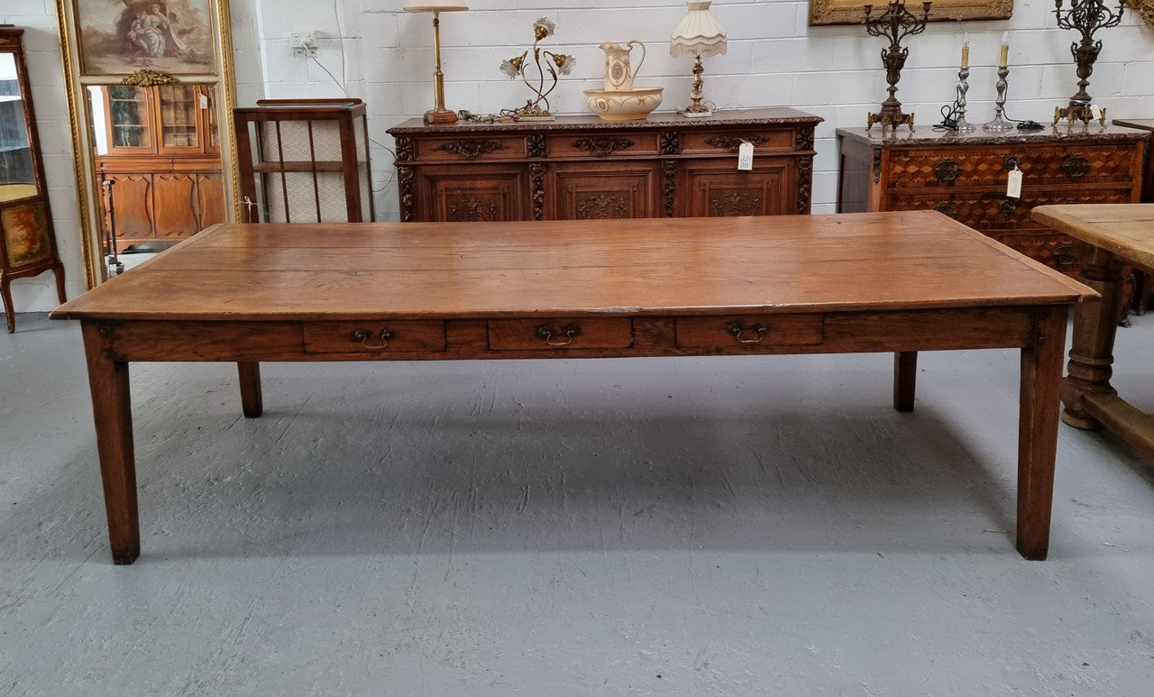 Amazing 19th Century French Oak Farmhouse style dining table with three drawers. It is made from three large planks of wood which is very hard to find. It is also very wide with a width of 105.5 cm. It is in good original detailed condition.
