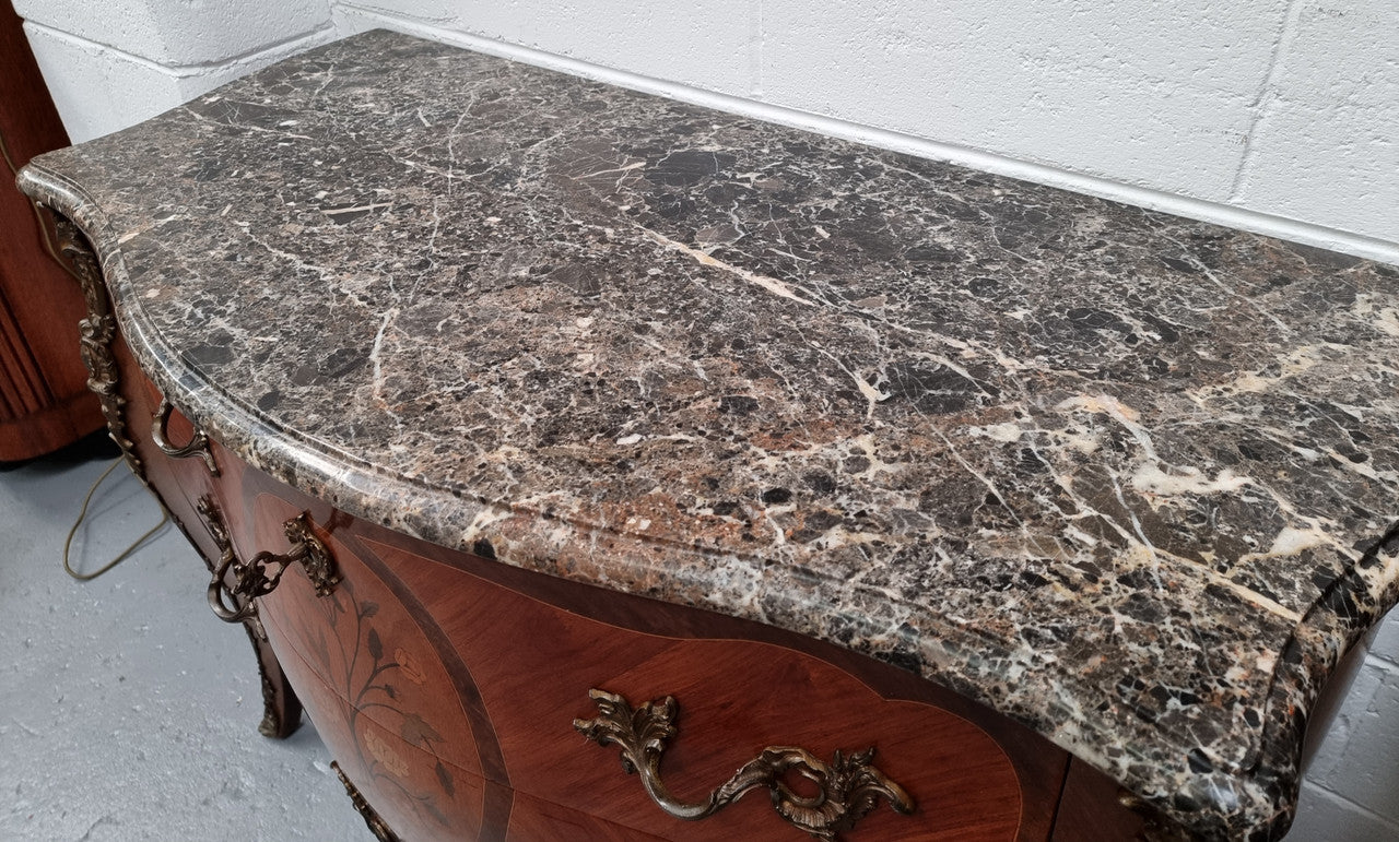 Beautiful French walnut Louis XV style two drawer commode. With a lovely floral marquetry inlaid design and marble top. It is in good original detailed condition.