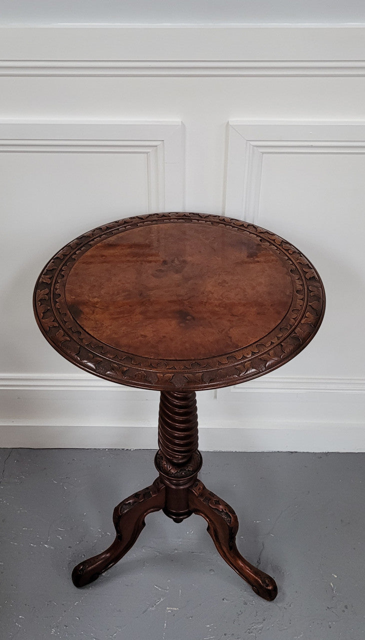 Rare early Victorian Irish Burr Walnut wine table. It has a beautiful carvings and a stunning burr walnut top, on a barley twist column and three shaped legs. It has been sourced locally and is in good original detailed condition. We also have a second table being sold separately which when together make a matched pair.