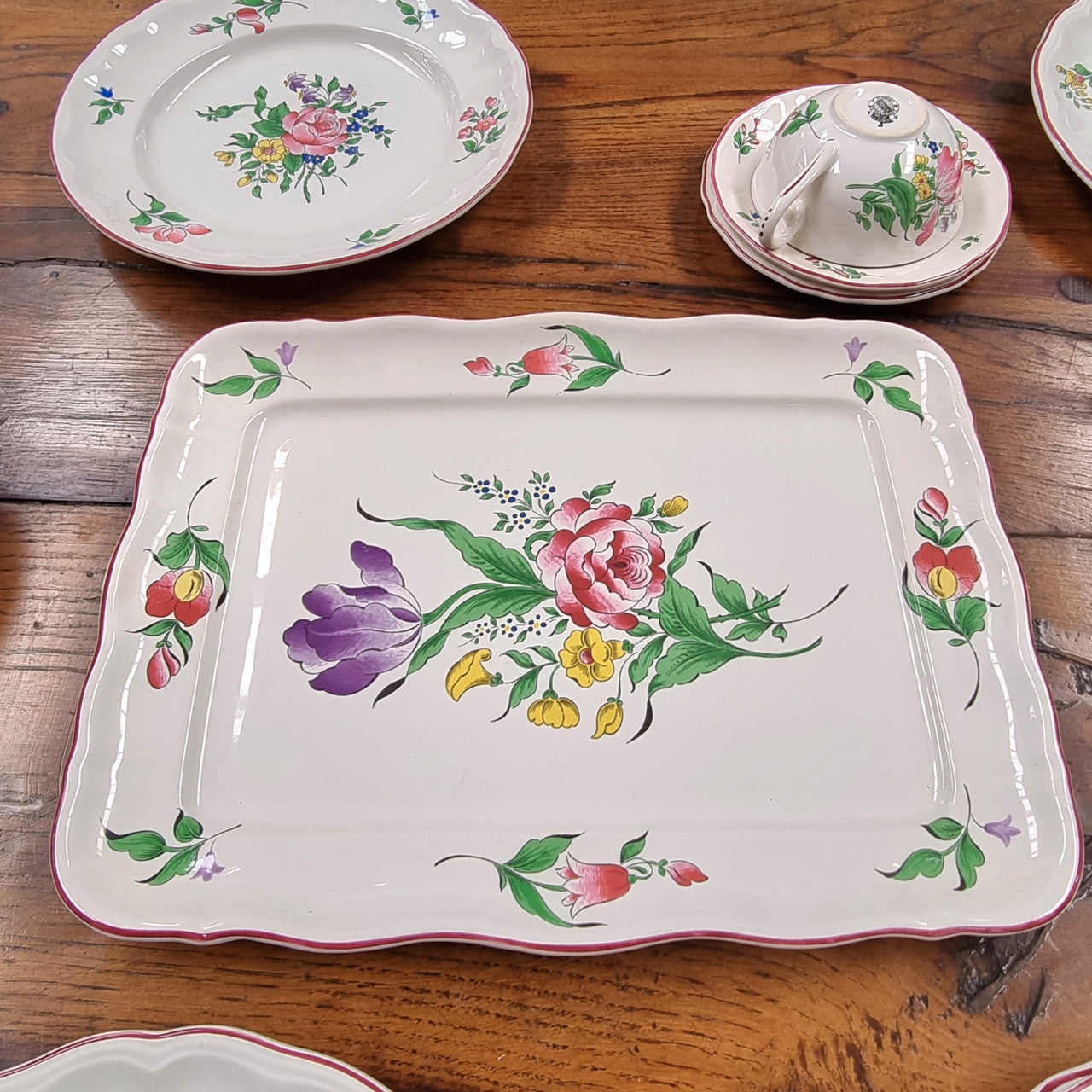 A pretty French table setting made in France called Luneville. It consists of plates, cups, saucers, tea pot, milk jug, sugar bowl, tureens and cake plates a total of 53 pieces. Please view photos as they help form part of the descriptions.