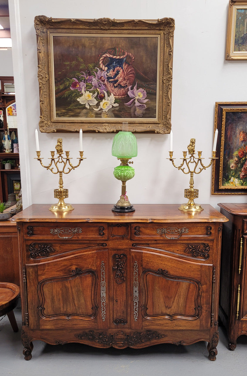 Attractive French Walnut Louis XV style two door two drawer sideboard featuring beautiful carving. Circa: 1930's. It has been sourced from France and it is in good original detailed condition.