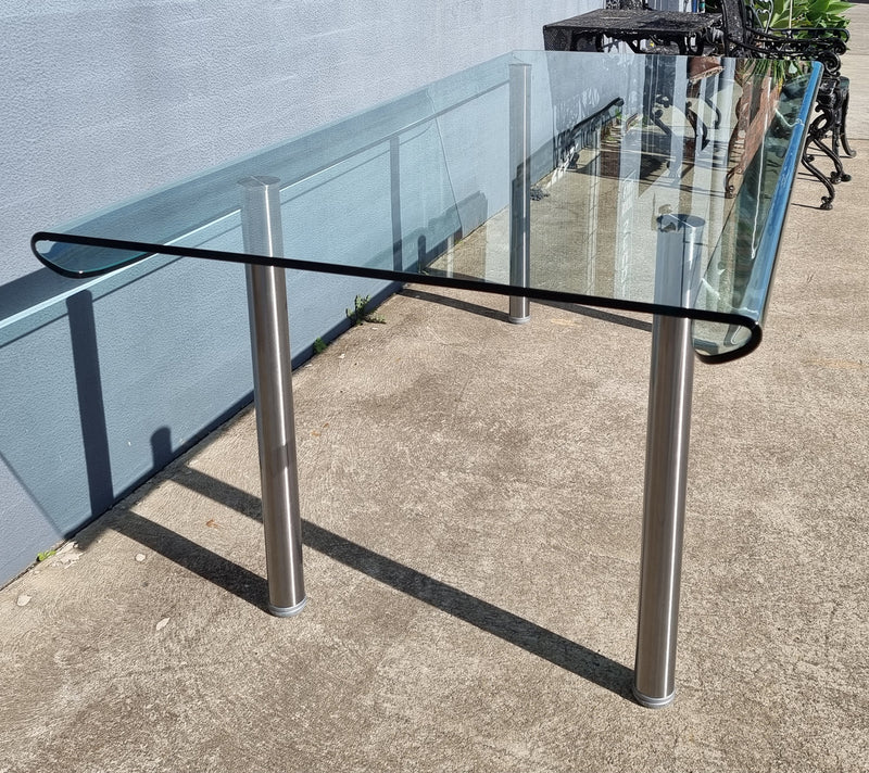 Striking and distinctive Vintage FIAM Italia Designer curved edge glass desk. FIAM was founded in 1973 by Vittorio Livio and has become synonymous with glass culture in Italy and the World. FIAM is still manufacturing today, in collaboration with various Designers, and has won numerous awards and is represented in various international museums. 
Condition: Evidence of use with minor scratches to the surface and a small chip that has been repaired. Overall, in very good condition with one repaired chip to t