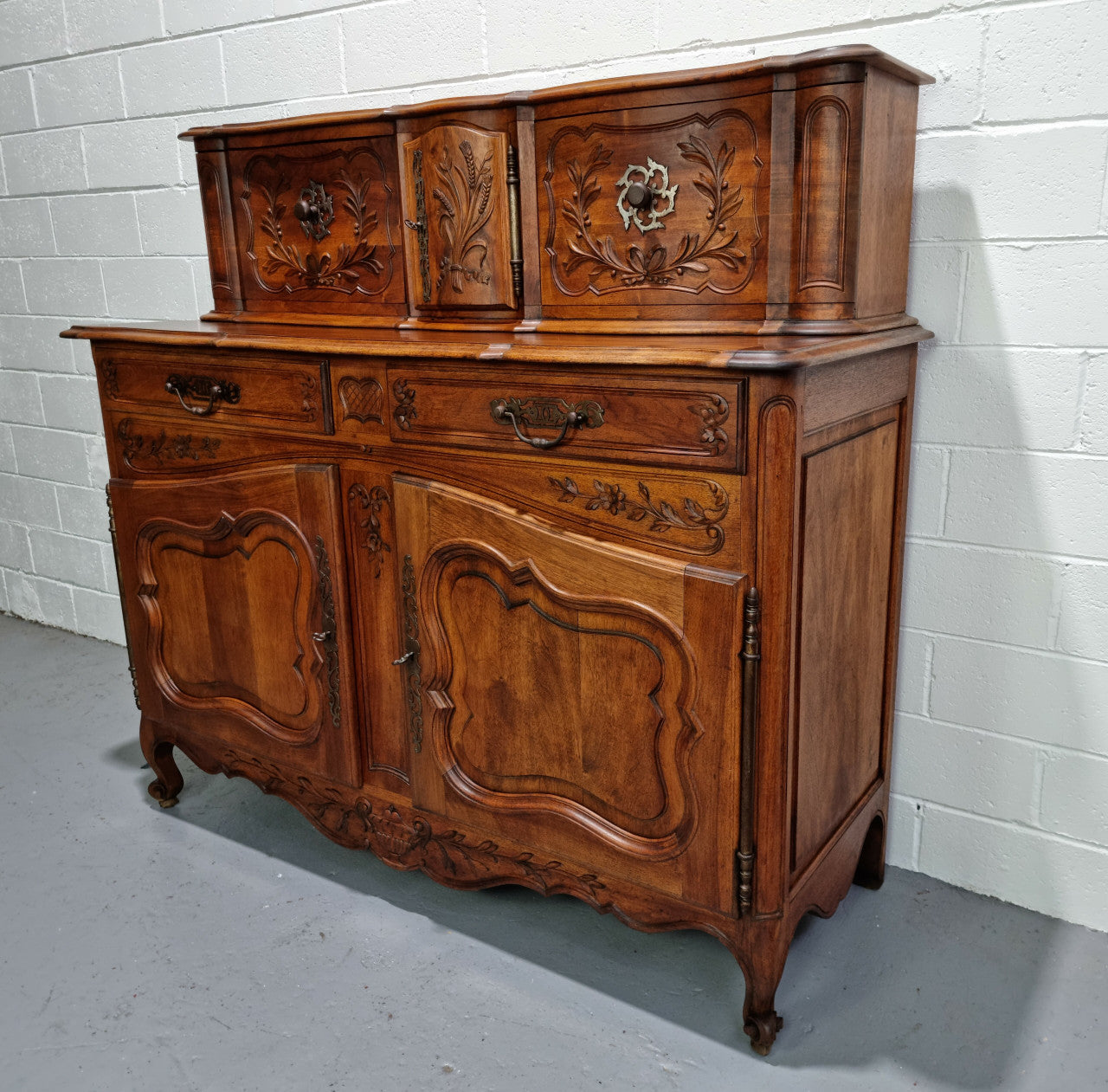 Stunning 19th Century French Walnut Buffet à Glissant from Provence, France. This is an exceptional charming piece and very functional with plenty of storage space, two large cupboards at the bottom, two drawers in the middle and two sliding doors either side at the top and finished off with a small central cupboard. In good original detailed condition.