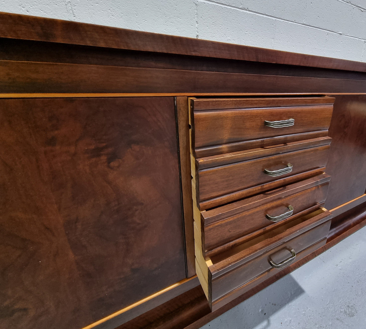 Amazing French Walnut Art deco four door buffet. The doors either side open to a fixed shelf and plenty of added storage with four drawers. In good original detailed condition.