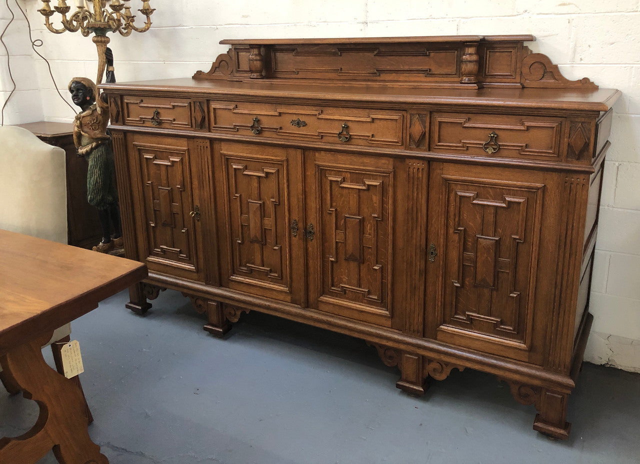 Beautiful carved French Oak four-door buffet with three drawers and lots of room for storage in good original detailed condition.