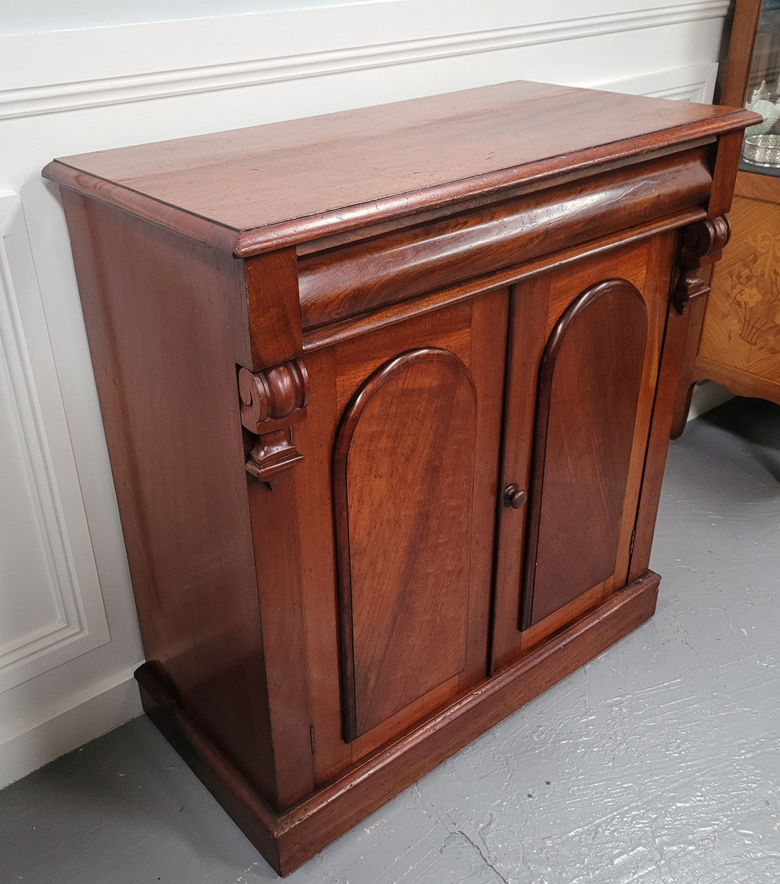 Cedar side cabinet with two doors one drawer and lovely door panels and corbels. It has been sourced locally and is in good original detailed condition.