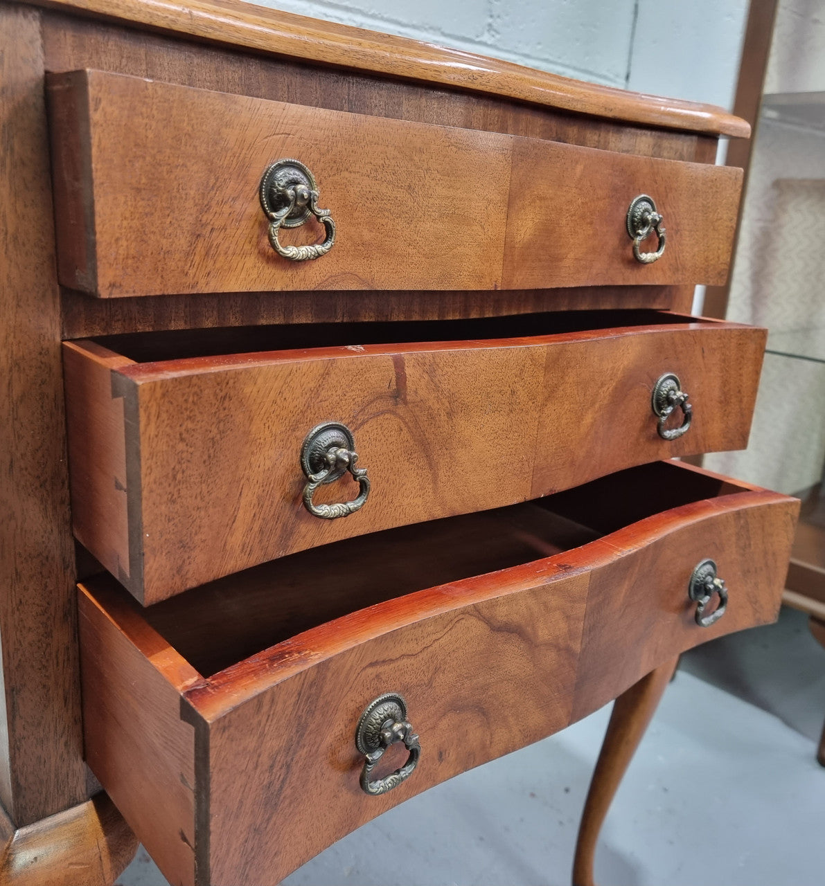 Antique Queen Anne style figured Walnut Bedside cabinet with 3 drawers. It is in good original detailed condition.