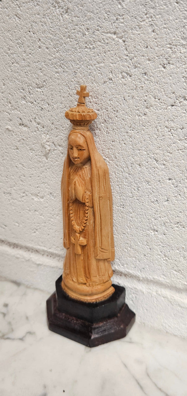 Vintage Olivewood statue of praying Virgin Mary on dark wooden plinth. Condition comensurate with age, please view photos as they help form part of the description.