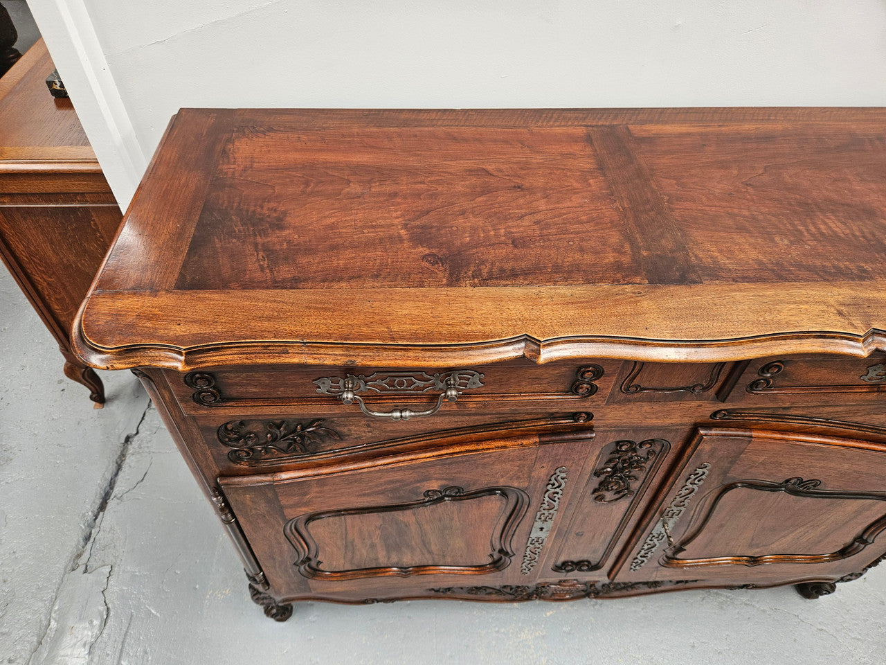 Attractive French Walnut Louis XV style two door two drawer sideboard featuring beautiful carving. Circa: 1930's. It has been sourced from France and it is in good original detailed condition.