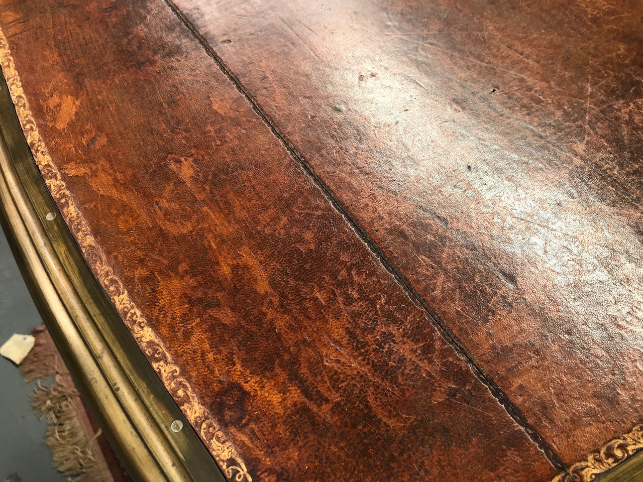 An impressive French Walnut petite Bureau Plat with superb ormolu mounts, original tooled leather top with loads of character and drawers for storage. It is in very good original detailed condition.