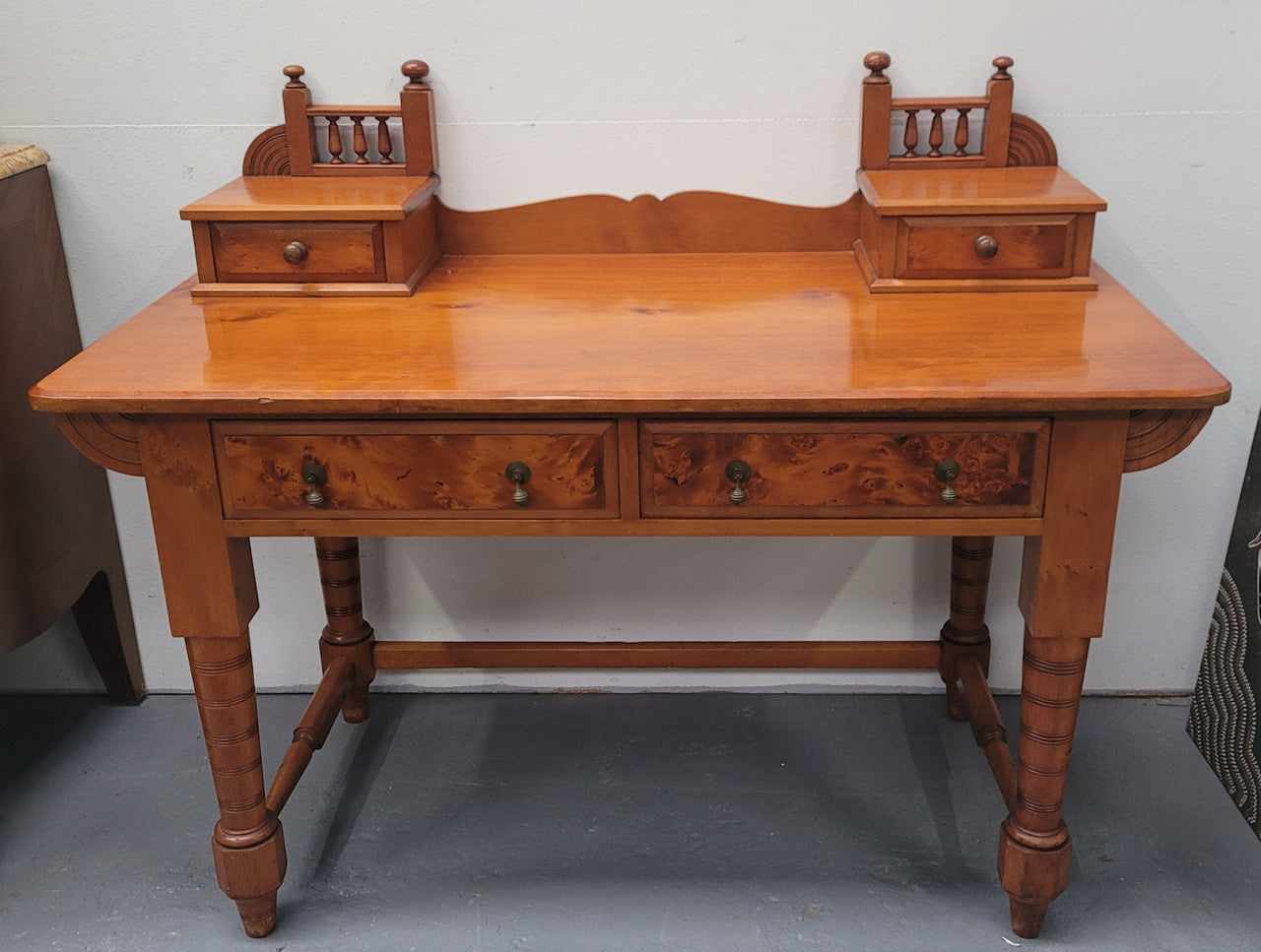Late Victorian Huon Pine desk with two drawers. Featuring superb birdseye panels and is in good original detailed condition.