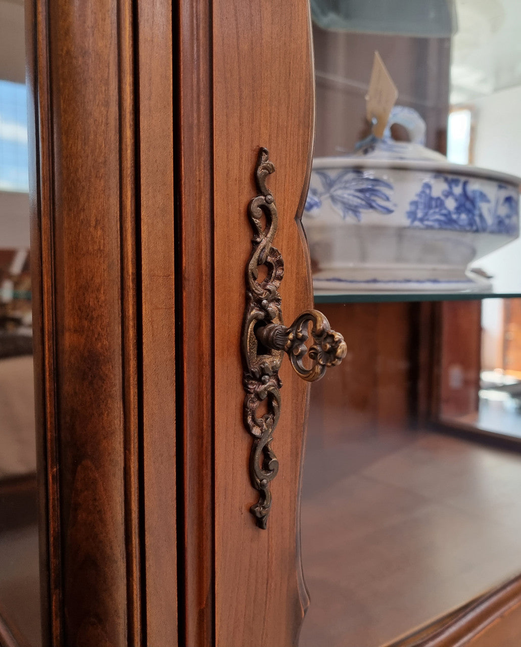 Petite French Louis XV style Walnut display cabinet with two glass shelves that can be adjusted and added storage at the bottom . In very good original detailed condition.