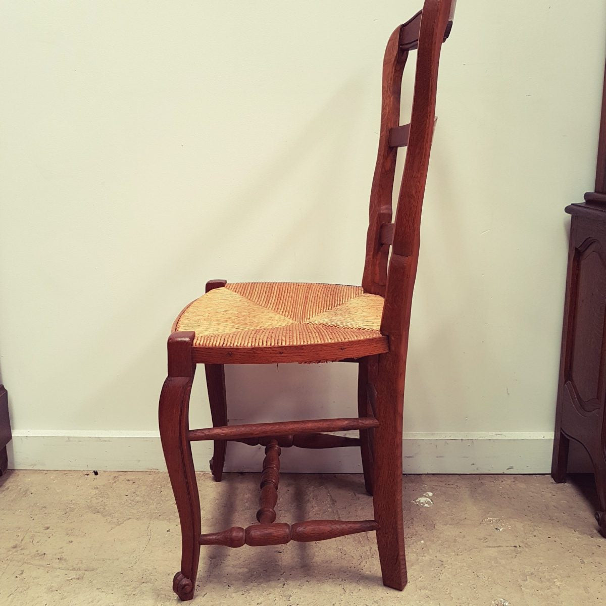 A set of six French Louis XV style, ladder back oak chairs. With finely carved detail and rush seat. In great original condition. Chairs are comfortable and sturdy for everyday use.