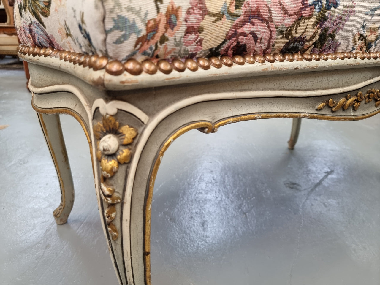 Antique painted Louis XV style upholstered stool. It has lovely floral upholstery that is in good condition with no tears. It is in good original detailed condition.