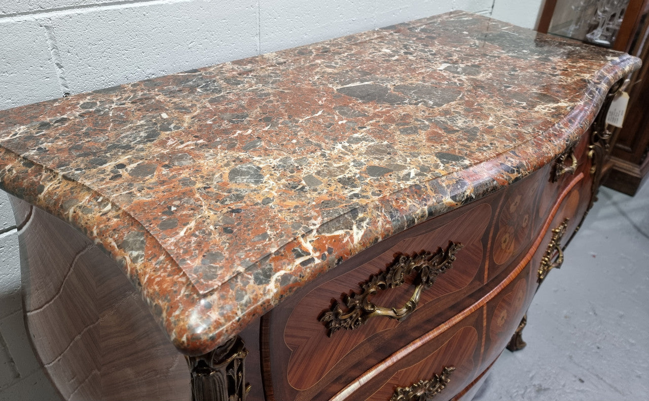 French Walnut and Kingwood Louis XV style marquetry inlaid commode with three drawers and a beautiful marble top. It is in good original detailed condition.