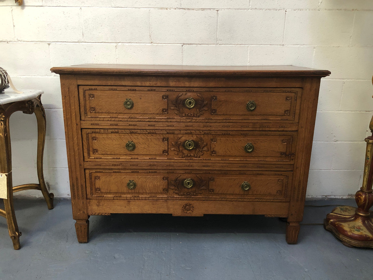 Lovely carved early 19th Century French Oak commode. There are three drawers with decorative drawer pulls and is in good original detailed condition.