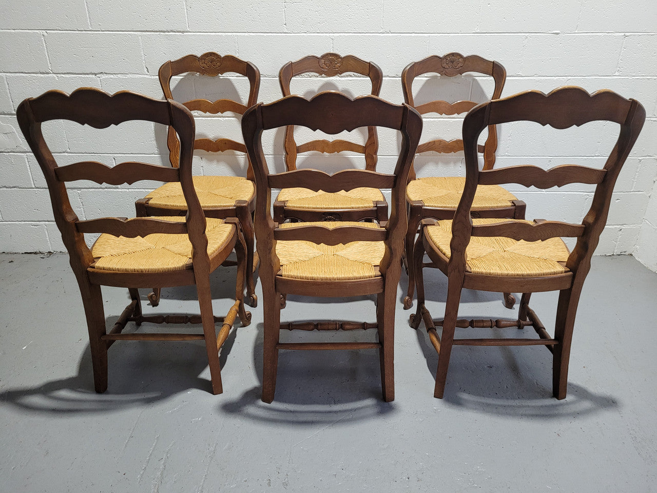 A stunning set of six French Louis XV Style oak dining chairs with rush seats in good original condition. All chairs have been detailed and re-glued where needed.