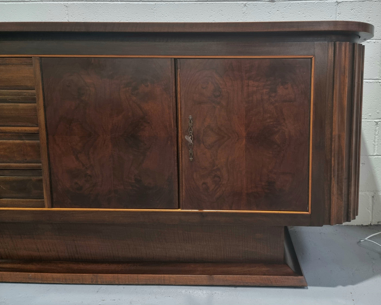 Amazing French Walnut Art deco four door buffet. The doors either side open to a fixed shelf and plenty of added storage with four drawers. In good original detailed condition.