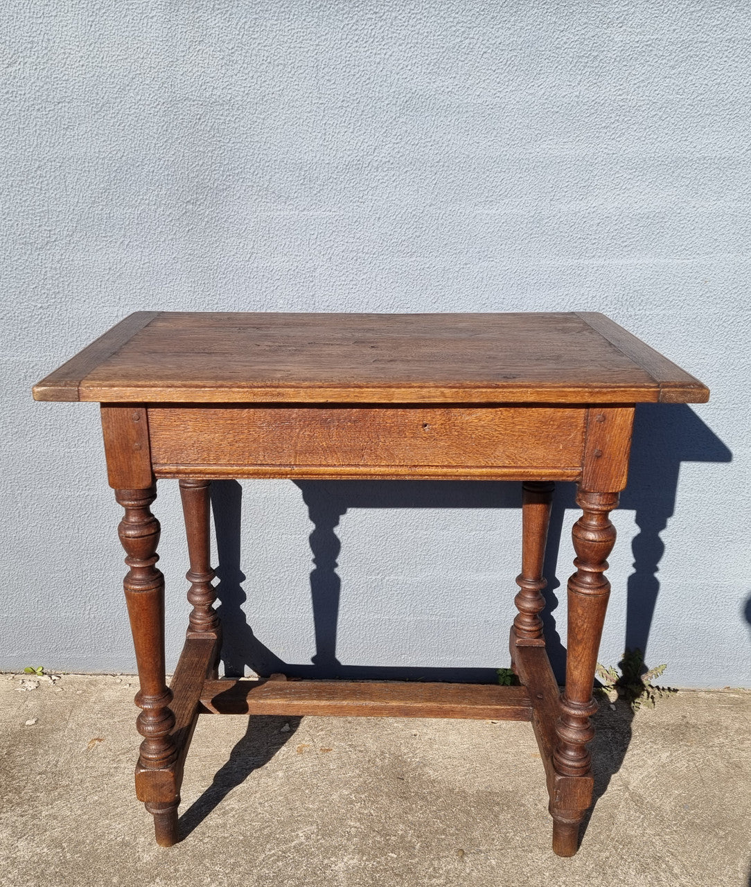 Lovely Oak Tudor style rope edge sideboard with leadlight centre door, three drawers and two solid cupboards. In good original condition.