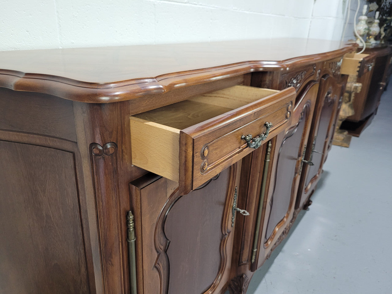 Walnut Louis XV style parquetry top four door sideboard with beautiful carving. Plenty of storage space and it is in good original detailed condition.