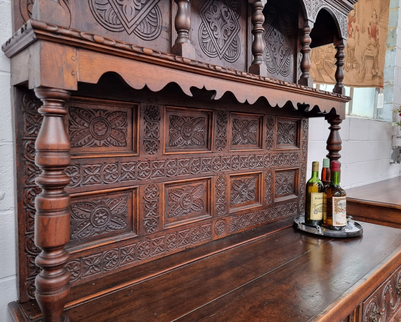 Impressively carved 18th Century English Oak kitchen dresser in 17th Century Jacobean style. It is in good original detailed condition and has been sourced from France.