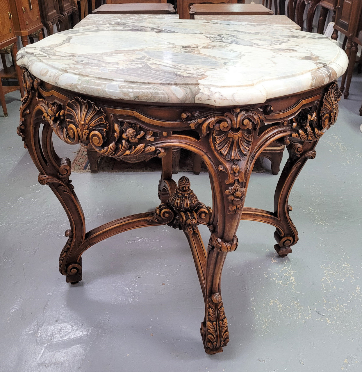 French Walnut Louis XV style round marble top centre table. It has amazing eye-catching marble, ornate detailed carvings and a beautifully carved undercarriage. In good original detailed condition.