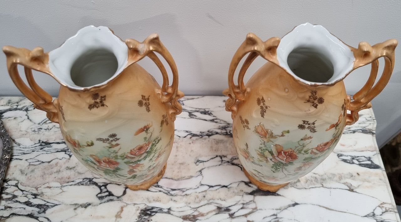 Decorative Pair of Art Nouveau Vases decorated with hand finished roses in muted tones. Gilt highlights. Impressed numbers to base. In good original condition, please view photos as they help form part of the description.