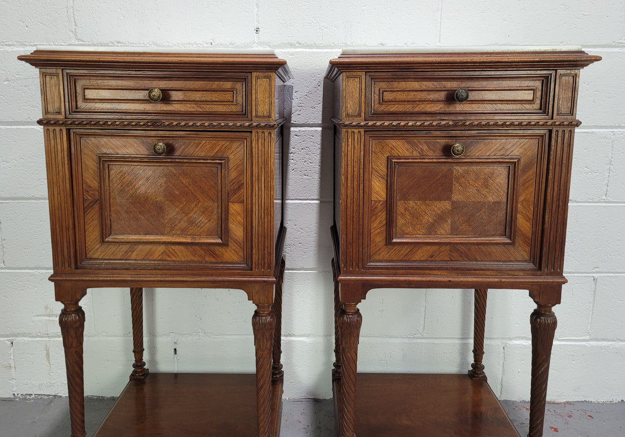 Pair parquetry Walnut bedside cabinets with white inset marble tops. In good original detailed condition.
