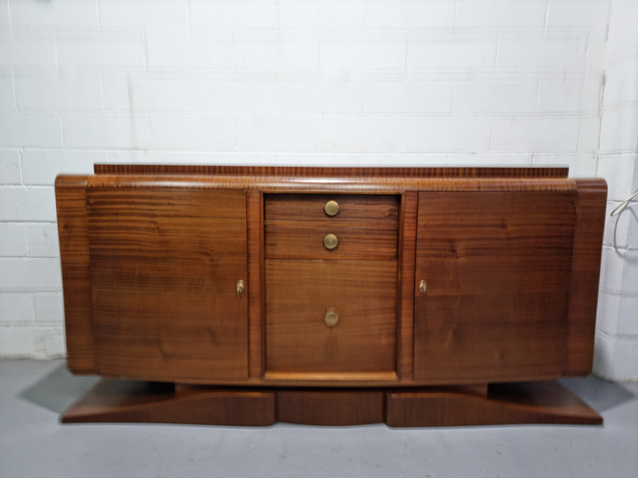 French Art Deco mahogany sideboard, a beautiful example from the Art Deco period. It has plenty of storage with three drawers and two shelved cupboards. It is in good original detailed condition. Circa 1920.