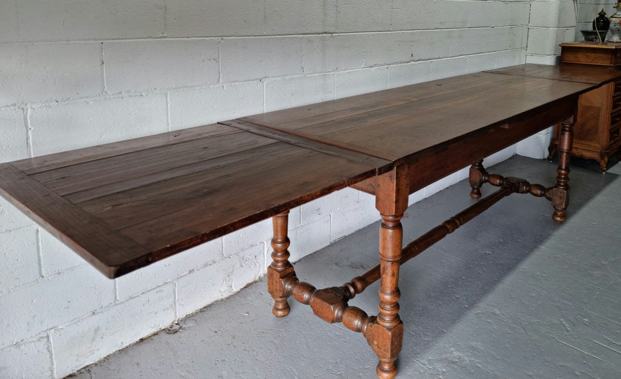 Appealing and rare French Oak Farmhouse extension table. Charming character to the top and comfortably seats 12 people. In good original detailed condition.