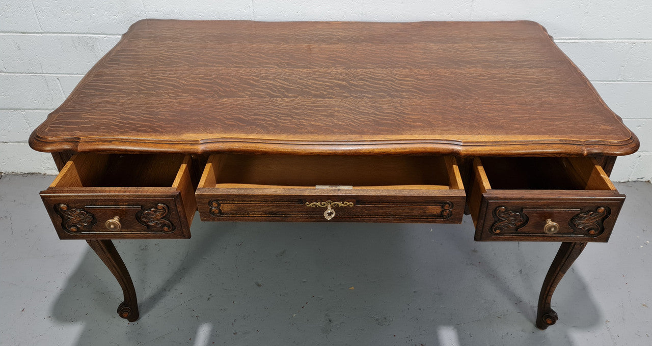 Attractive large Louis XV style Oak faux partners desk. Nicely carved details with three large functioning drawers, and three faux drawers at the back. In good original detailed condition.
