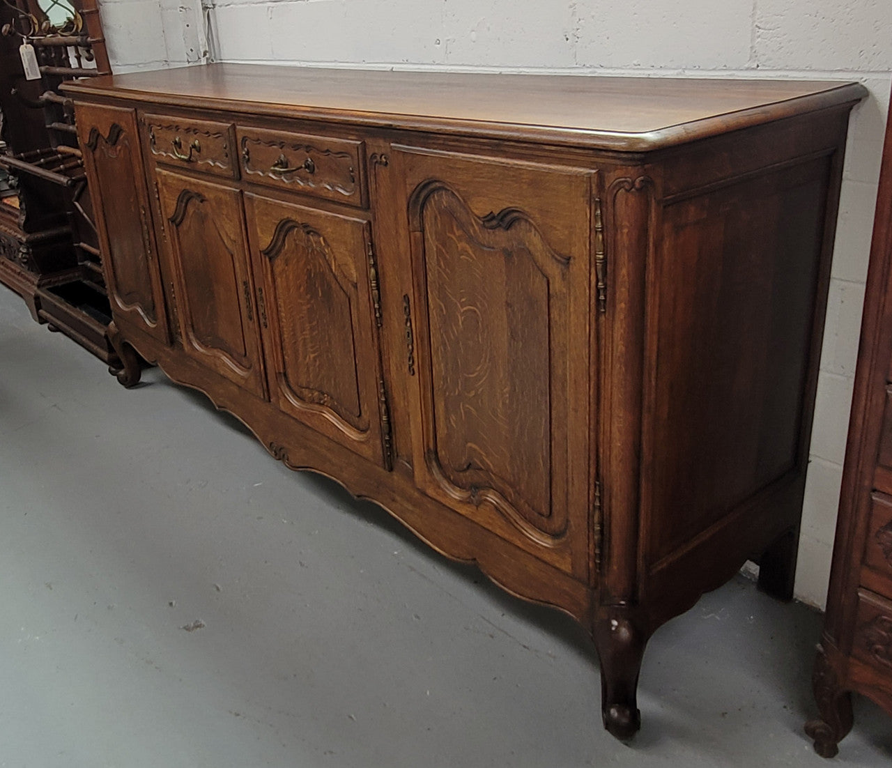 Louis XV style French Oak sideboard consisting of four doors and two drawers. It is in good restored condition.
