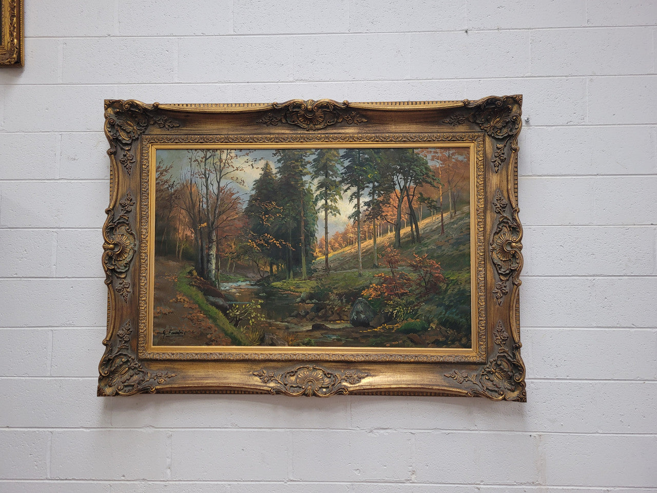 Large signed oil on canvas depicting a river stream in autumn framed in a stunning gilt frame. Sourced from France and is in good original detailed condition.