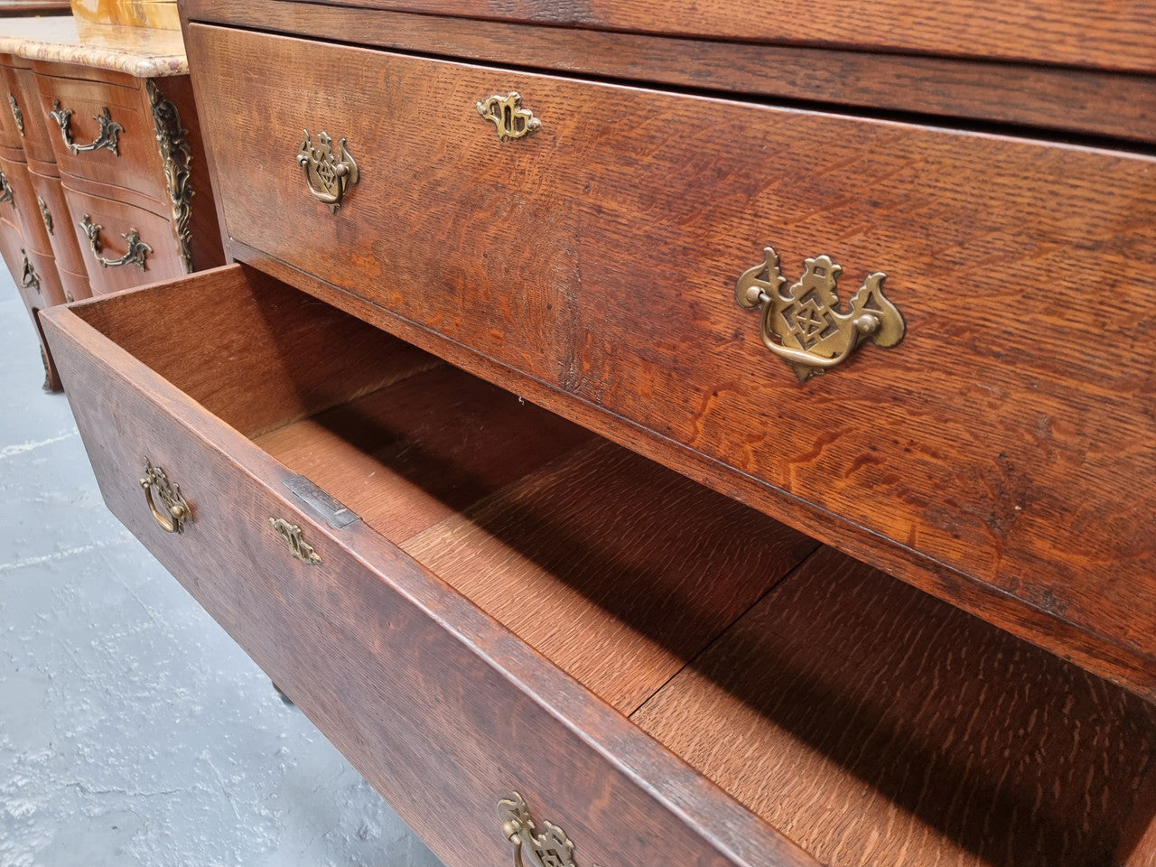 Early 19th Century English Oak chest on stand. It has been sourced in France and has plenty of storage space with eight drawers. In good original detailed condition.
