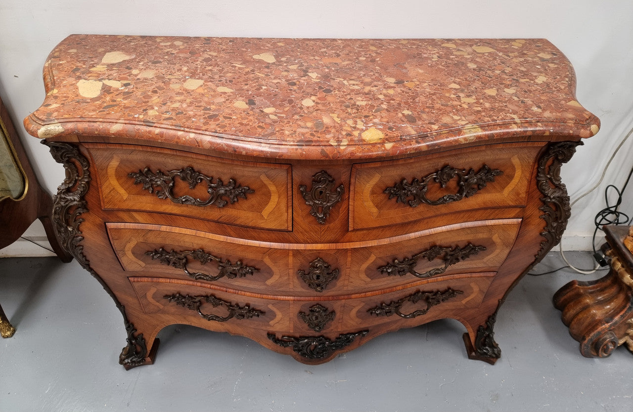 Sensational Grand French Walnut Bombe Commode with beautiful marquetry inlay. It has lovely decorative hardware and an amazing marble top in good original detailed condition.