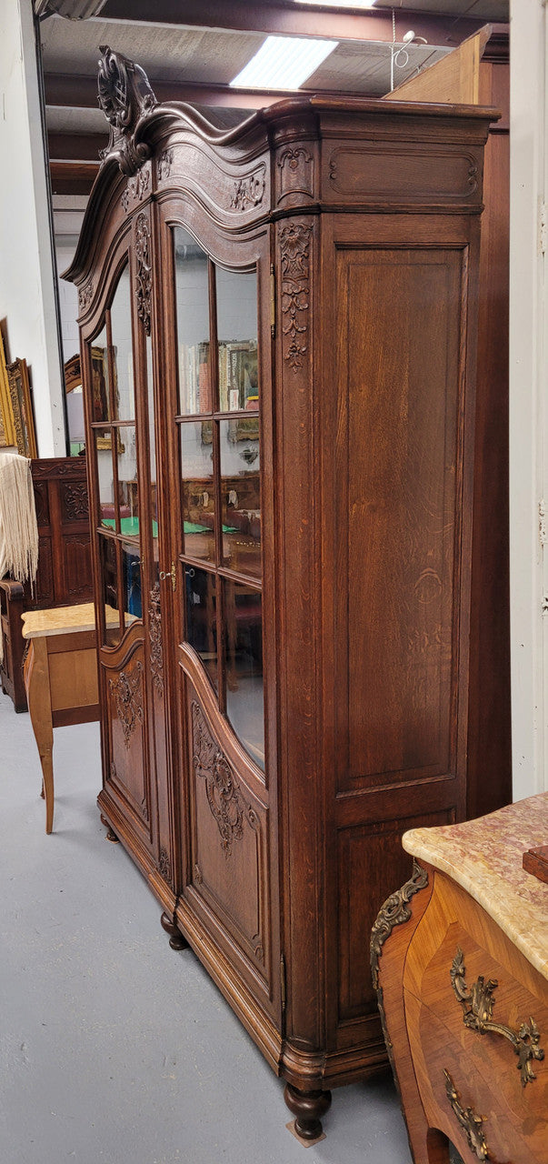 Substantial French Oak Louis 15th Style large two door bookcase. Adjustable shelves and very decorative carving. In good original detailed condition.
