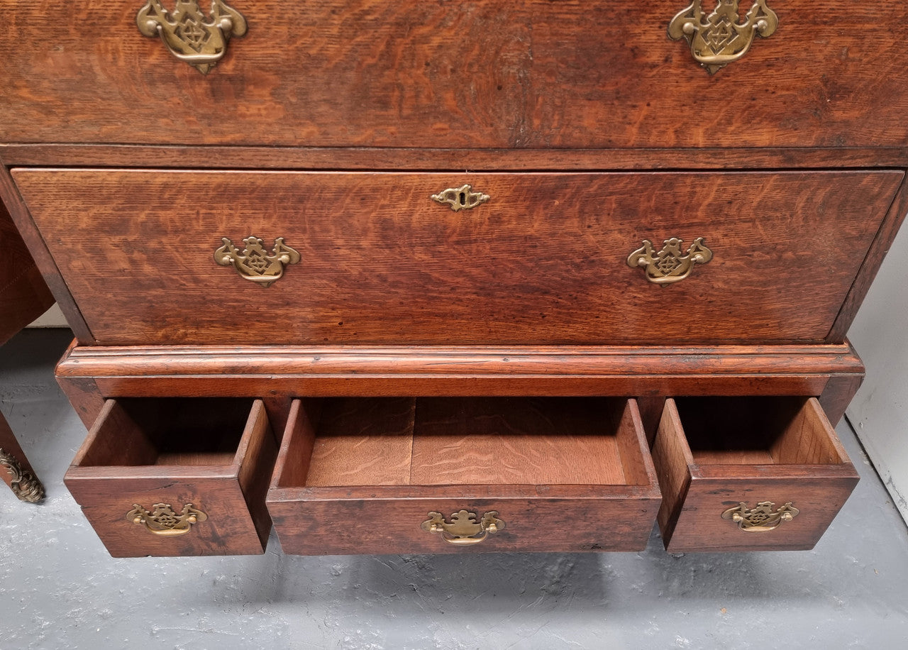 Early 19th Century English Oak chest on stand. It has been sourced in France and has plenty of storage space with eight drawers. In good original detailed condition.