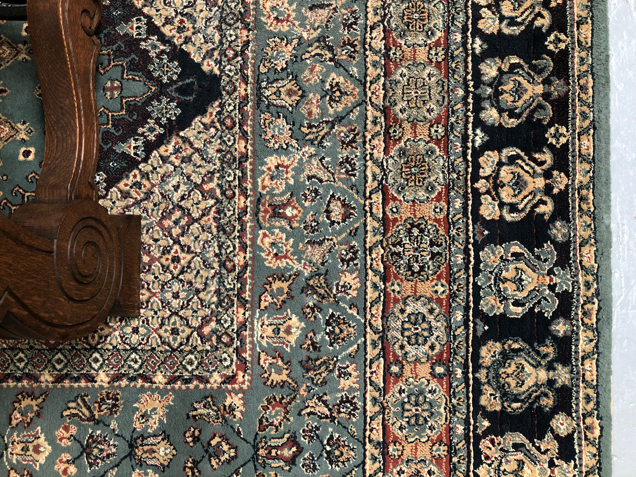 A beautiful coloured Turkish Rug with shades of green, teal, navy and rust in good condition.