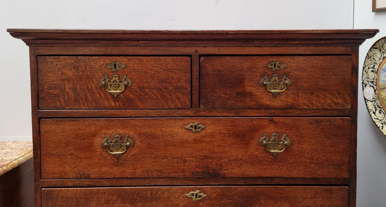 Early 19th Century English Oak chest on stand. It has been sourced in France and has plenty of storage space with eight drawers. In good original detailed condition.