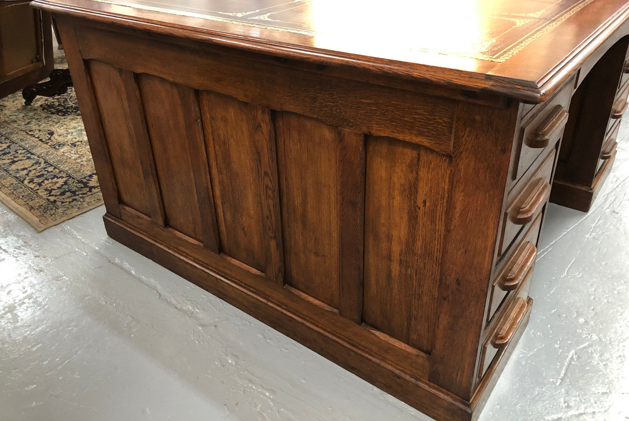 Lovely large English oak partners desk, with a beautiful burgundy tooled leather top. Plenty of storage space, both sides have 9 functioning drawers. It is in very good condition.