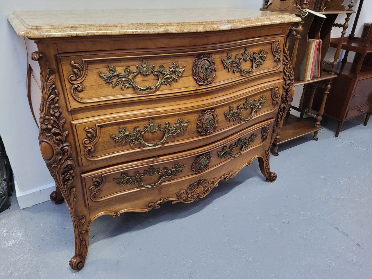 Impressive Louis XV style three drawer walnut commode. Ormolu handles and bevelled marble top complimenting detailed carving. In very good original detailed condition.
