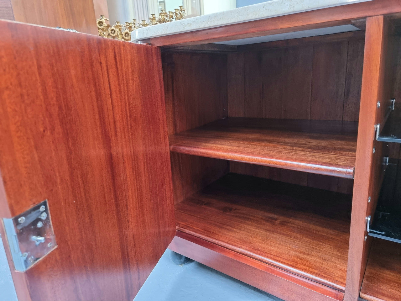 Beautiful Bespoke Art Deco style walnut and mahogany low line cabinet with a marble top and plenty of storage. It has two doors with a shelf each side and in the middle in has two glass shelves. Would make an ideal TV cabinet and has a hole in the back to run cords through. In very good original detailed condition.