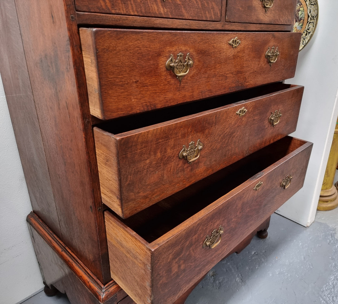 Early 19th Century English Oak chest on stand. It has been sourced in France and has plenty of storage space with eight drawers. In good original detailed condition.